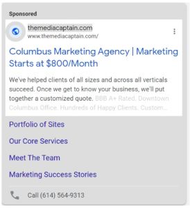 A Google sponsored text ad for The Media Captain titled "Columbus Marketing Agency | Marketing Starts at $800/Month," complete with sitelink extensions and a phone call extension.